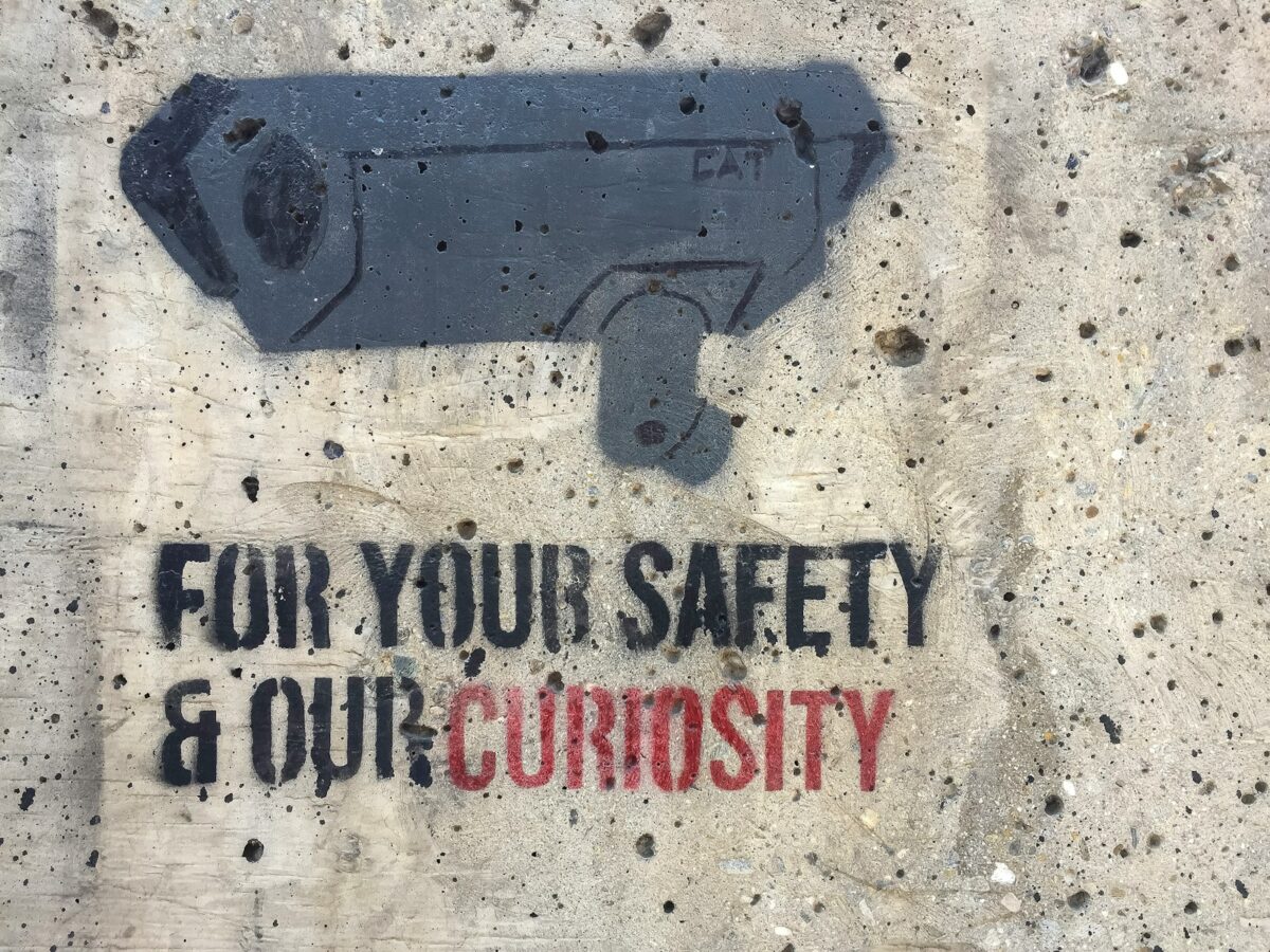 Security camera stencil with text on wall