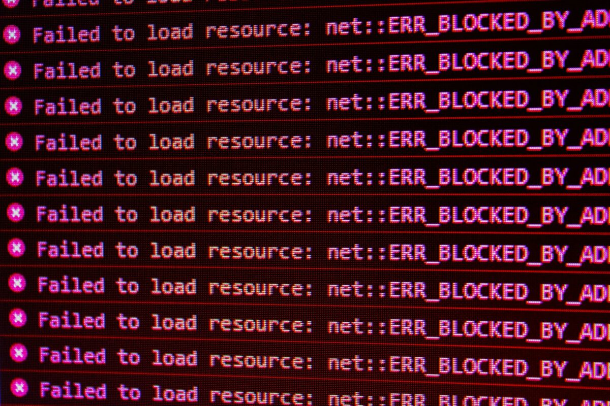 Red error messages on a black computer screen indicating blocked web resources